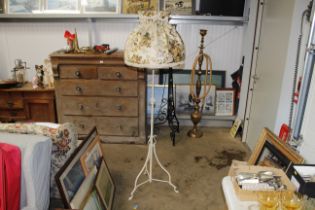 A metal standard lamp and floral shade