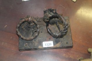 A vintage door lock and two wrought iron door hand