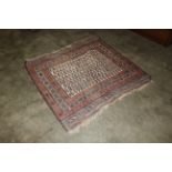 An approx. 4'5" x 4'7" blue and red pattern rug