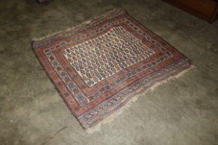 An approx. 4'5" x 4'7" blue and red pattern rug