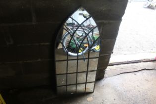 A tall arched outdoor mirror (127)