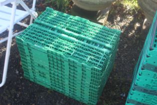 A quantity of green plastic folding crates