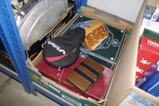 A box containing various games and a cased table t