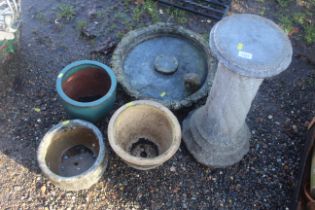 A concrete pedestal bird bath and three various pl