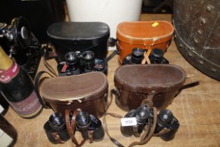 Four pairs of binoculars with cases