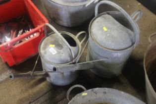 A 1½ gallon galvanised watering can and one other
