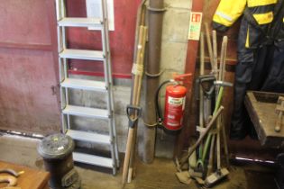 A small quantity of wooden tool handles and a metal crow bar etc.