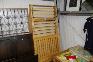 A wooden single trundle bed frame lacking mattress
