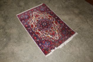 An approx. 3'7" x 2'4" red and blue floral pattern