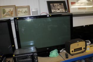 A large LG flat screen plasma tv with remote control