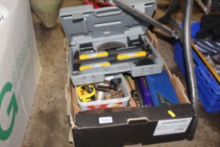 A box containing various tools to include an adjus