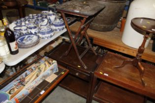 A small carved folding side table