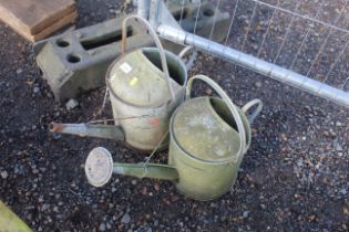 Two galvanised watering cans (one with rose)