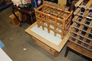 A wooden and wicker coffee table with draw and a w