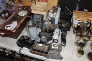 A quantity of cameras, binoculars, projector etc.