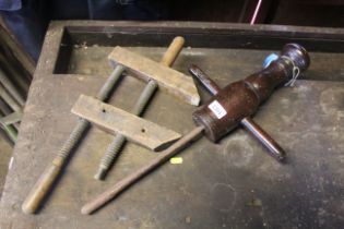 A double screw wooden clamp and a large twin handled borer. Vendor reports these were previously