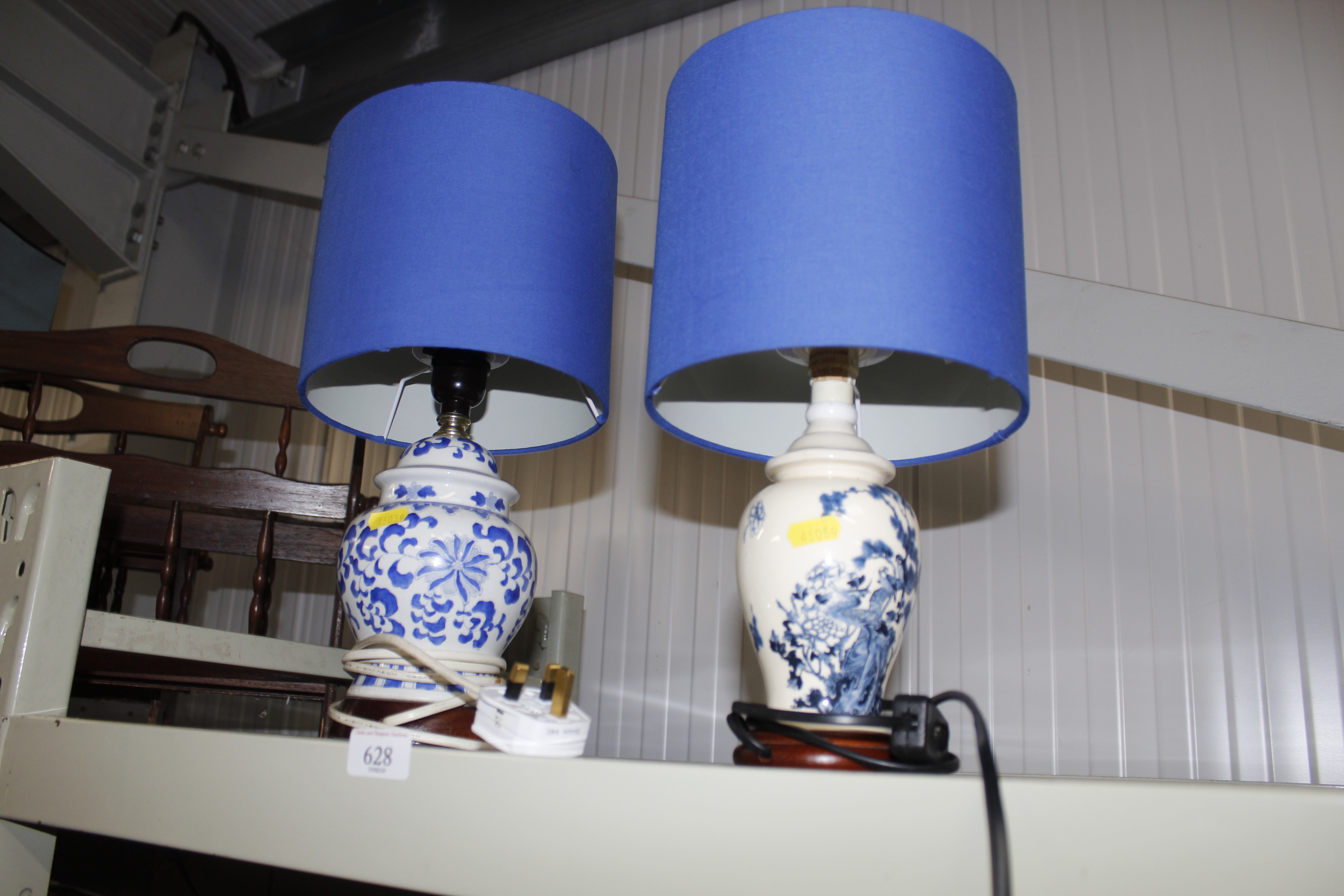 Two blue and white base table lamps with blue shad
