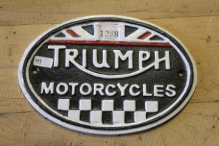 A painted oval cast iron sign for "Triumph Motor C