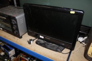 A small Phillips flat screen tv with remote contro