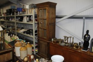 A tall pine and half glazed bookcase