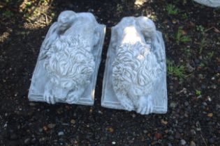 A pair of cast concrete garden ornaments in the form of  Chatsworth lions