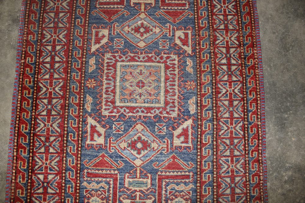 An approx. 4'4" x 3' red and blue pattern wool rug - Image 2 of 3