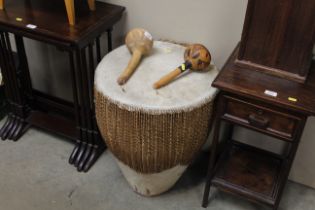 A large ethnic drum and two maracas