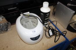 An UltraSonic jewellery cleaner and part bottle of