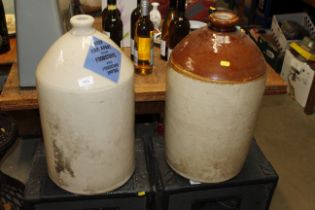 Two large stoneware jugs with a sign for 'Keep Far