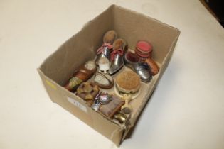 A box of various pin cushions including shoe shape