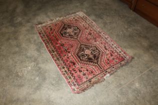 An approx. 4'6" x 2'11" red Eastern pattern wool r