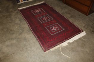 An approx. 7'2" x 3'10" red pattern Eastern rug AF