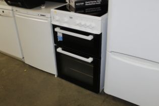 A Beko free standing oven with four ceramic plates