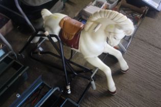 A child's rocking horse on metal frame