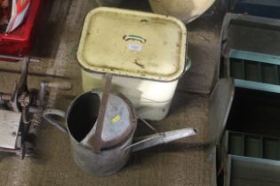 An enamelled bread bin and a galvanised 1½ gallon watering can