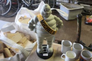 A painted cast iron figure of Michelin Man standin