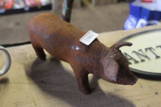 A small cast iron pig figure (102)