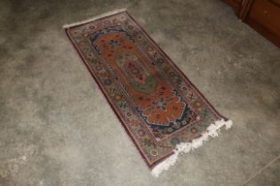 An approx.. 4'9" x 2' Eastern pattern wool rug