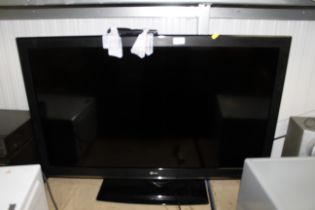 An LG flat screen tv with remote control