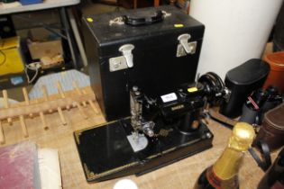 A Singer electric sewing machine in case, lacking