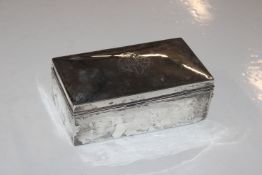 A silver cigarette box with wooden liner, approx.