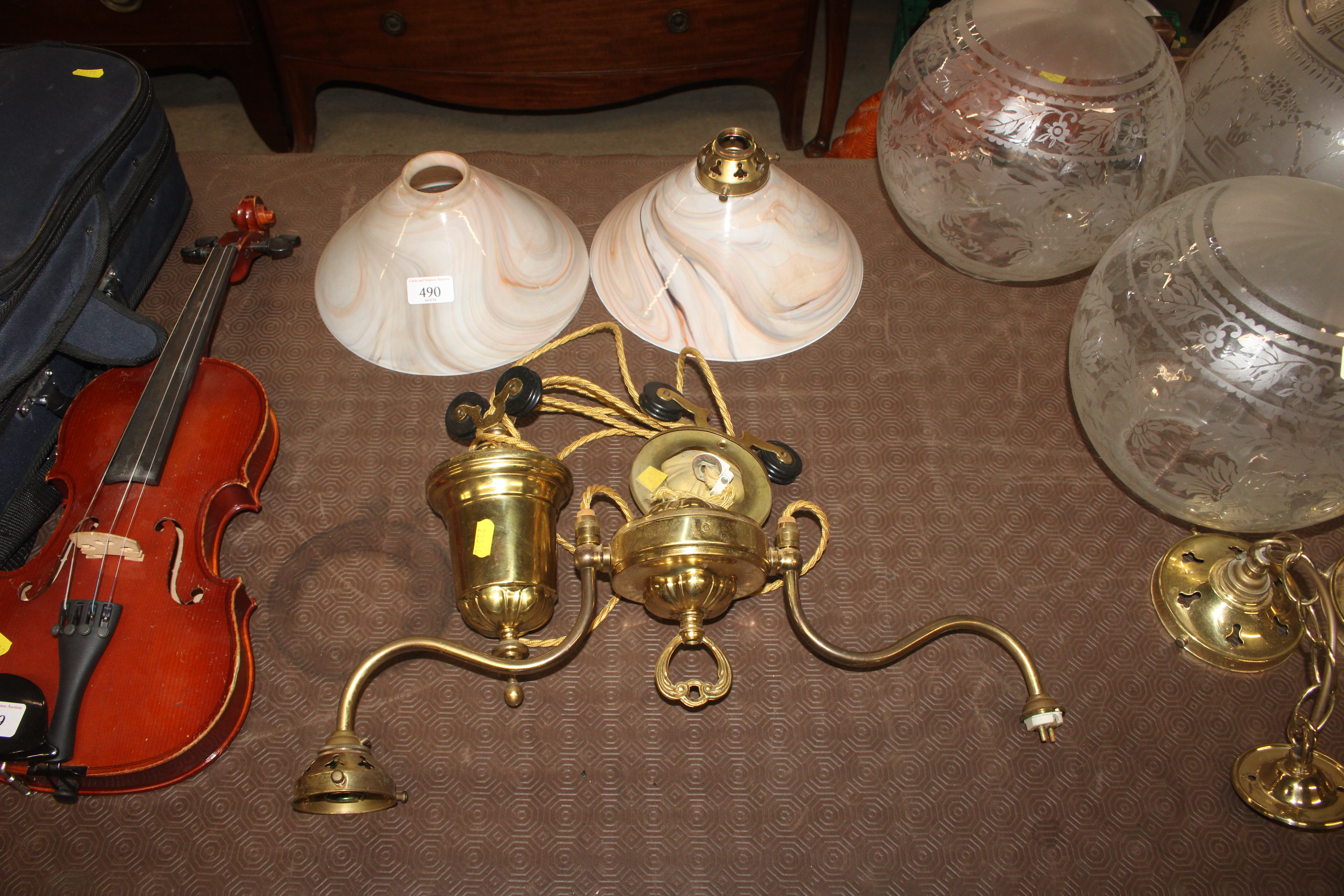 A brass rise and fall twin branch ceiling light wi
