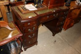 A reproduction mahogany pedestal writing desk