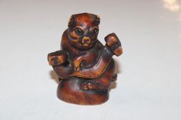 A Japanese carved wooden Netsuke in the form of a