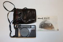A Nikon L35AF 35mm camera with case and manual