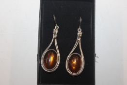 A pair of large silver and amber drop ear-rings, a