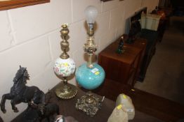 Two pottery and gilt metal table lamps, one in the
