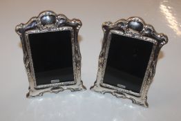 A pair of silver easel photo frames