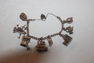 A silver charm bracelet hung with various silver a