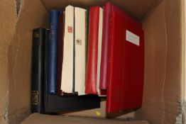 A large box containing various stamp albums
